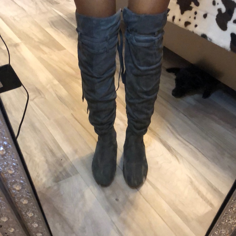 Grey suede thigh high boots.